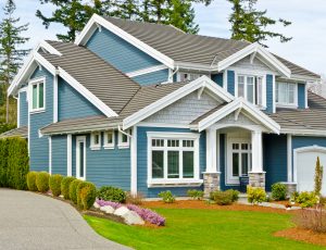 A beautiful home with blue siding and gray roofing.
